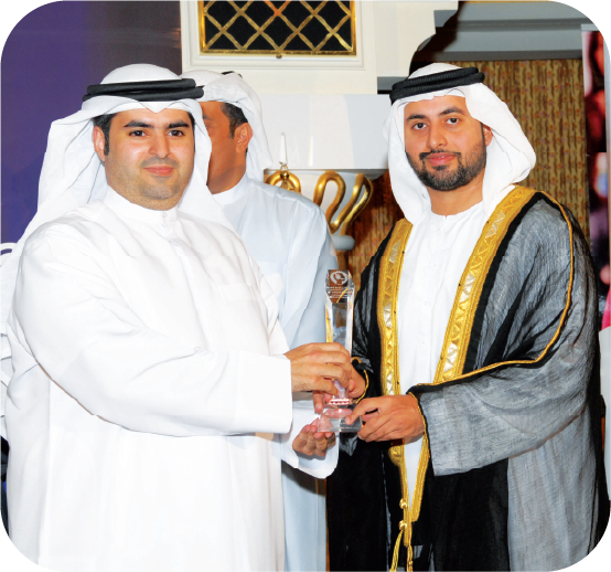 Honouree receiving a crystal award from a distinguished guest